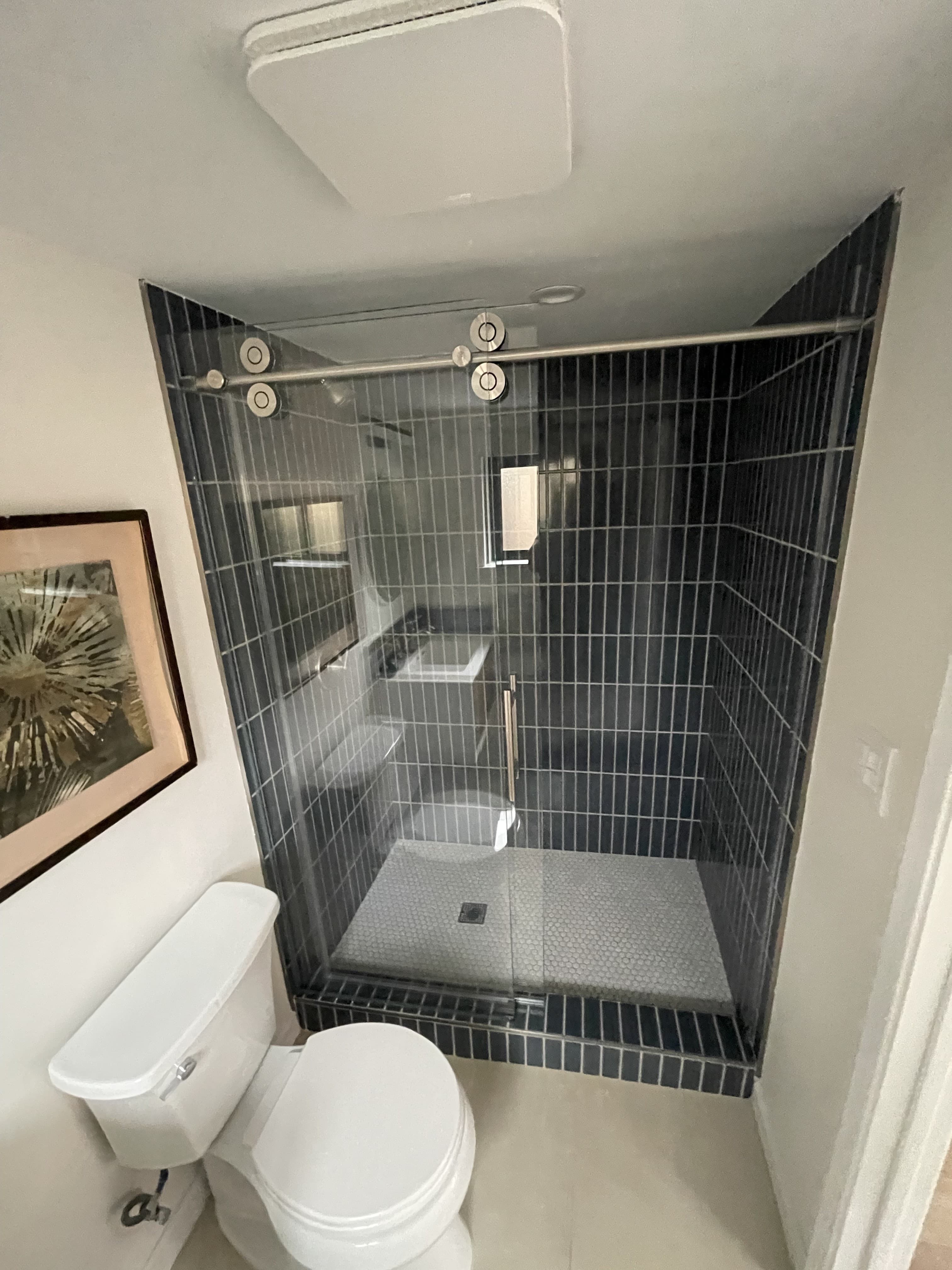 Walk-in shower with dark tile surround – Bay Area