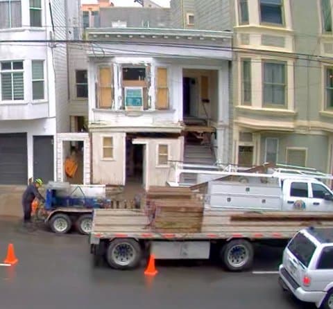 A Mission District home raised on hydraulic jacks during a house lift